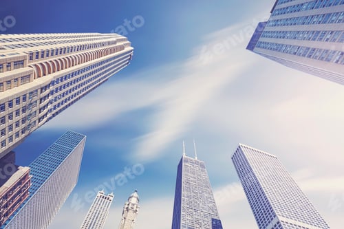 Preview: Color toned photo of Chicago skyscrapers with motion blurred clo