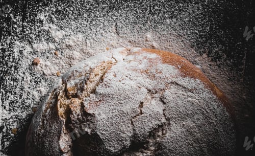 Preview: dark homemade bread dusted with flour
