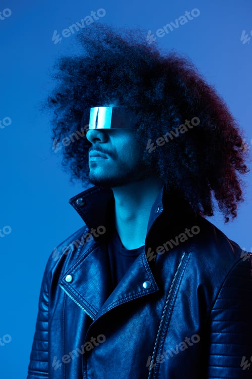Preview: Portrait of fashion man with curly hair with stylish glasses on blue background multinational