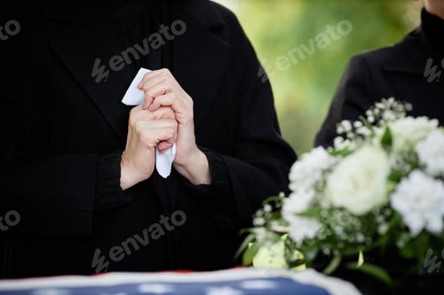Preview: Woman crying at outdoor funeral ceremony