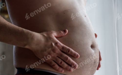 Preview: guy holding his fat in hand and stay near window