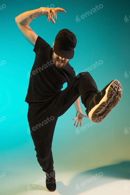 Preview: The Silhouette Of One Hip Hop Male Break Dancer Dancing On Colorful Background