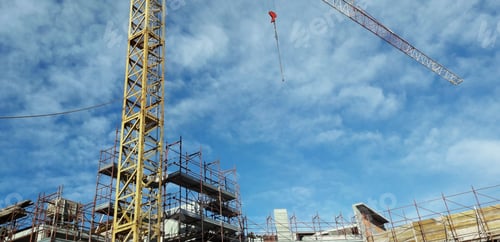 Preview: Tall crane at a construction site under a wispy sky