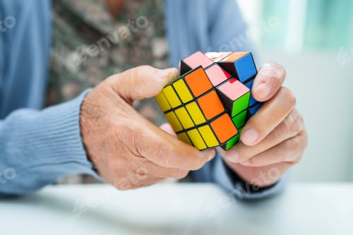 Preview: Alzheimer disease AD, Asian elderly woman patient playing Rubik cube game to practice brain