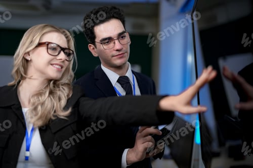 Preview: software developers smile with satisfaction during a pair programming session