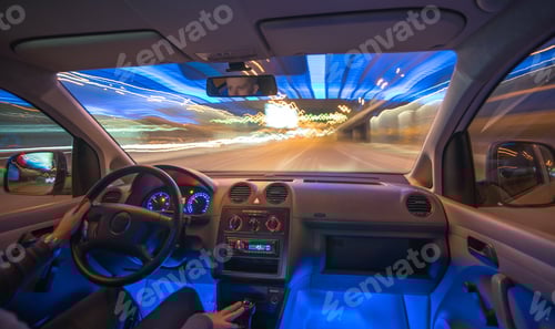 Preview: The man drive a car in the city with a lights. Evening night time