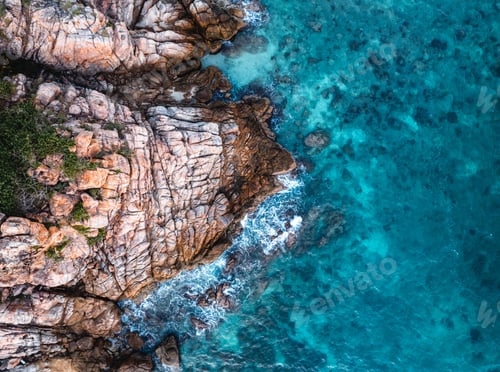 Preview: Blue sea and rocks on the island form above