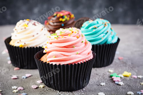 Preview: Tasty colorful cupcakes isolated on grey background. Delicious cupcake