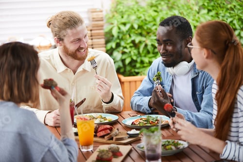 Preview: Young people eating meal in cafe