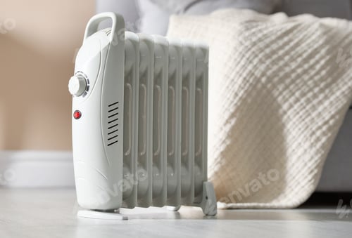 Preview: Electric heater on floor indoors, closeup. Space for text