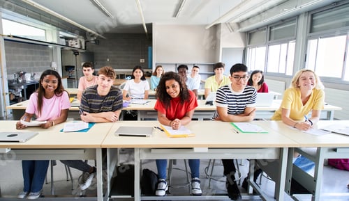 Preview: Smiling group university college sitting at classroom looking at camera. Portrait cheerful Students