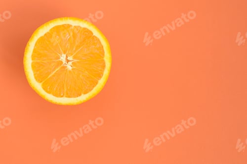 Preview: Top view of a one orange fruit slice on bright background in orange color