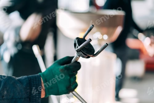 Preview: Professional mechanic holding wrench for removing the oil filter for internal combustion engines