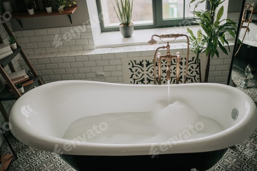 Preview: Luxury interior of eco style modern bathroom with oval bathtub and accessories at natural lighting