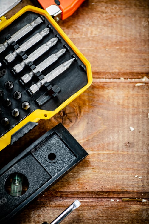 Preview: Working tools. Screwdriver bits. On a wooden background.
