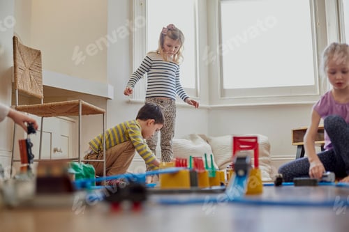 Preview: Children Playing with a Toy Train Set at Home
