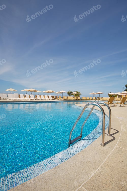 Preview: Beautiful blue sky and swimming pool with its staircase.