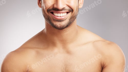Preview: Closeup young mixed race man shirtless in studio isolated against a grey background. Hispanic well