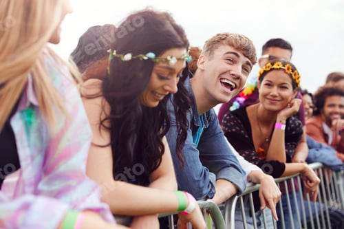 Preview: Group Of Young Friends Waiting Behind Barrier At Entrance To Music Festival Site