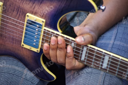 Preview: Diverse black unrecognizable male guitarist musician holds electric guitar