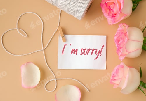Preview: Tender pink roses with spool of white cotton rope in heart shape on beige background. Paper note