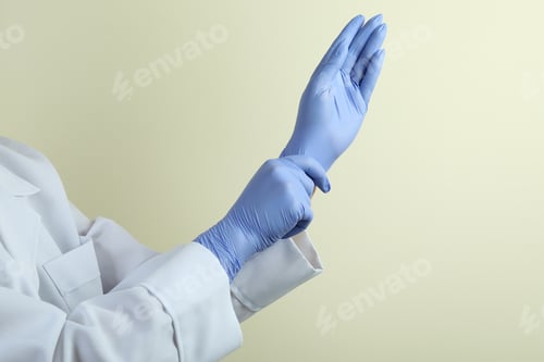 Preview: Medical Professional Putting On Protective Glove in Studio