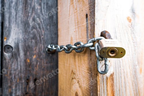 Preview: Iron lock on a closed door in an old house