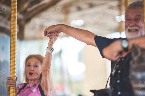 Preview: senior old couple celebration for Valentine's Day at Amusement theme park enjoying freedom relaxing