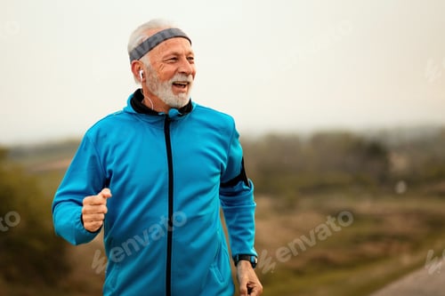 Preview: Happy mature athletic man running in nature.