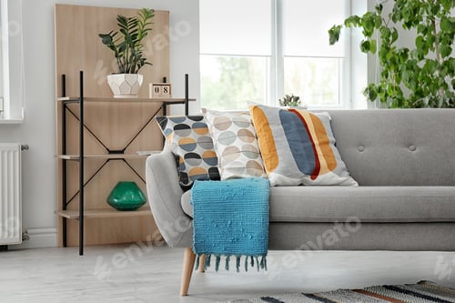 Preview: Elegant sofa with soft pillows in living room interior