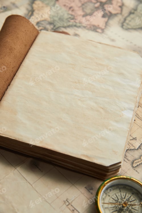 Preview: vintage blank notebook near compass on map background