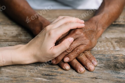 Preview: Young man holding senior woman hands, closeup