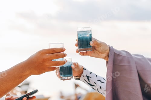 Preview: Group of hands cheering a drink