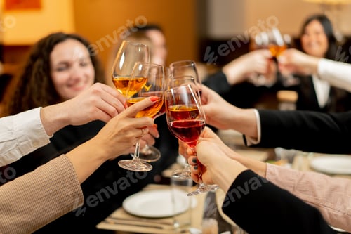 Preview: colleagues in a restaurant celebrating the conclusion new deal toasts with glasses of wine close-up