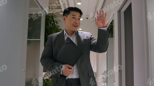 Preview: Asian middle-aged korean businessman adult chinese japanese ethnic man hold document folder walk to