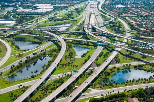 Preview: Aerial view of American freeway intersection with fast driving cars