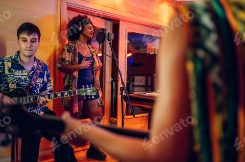 Preview: Diverse music band performing and recording a new song album in a music studio