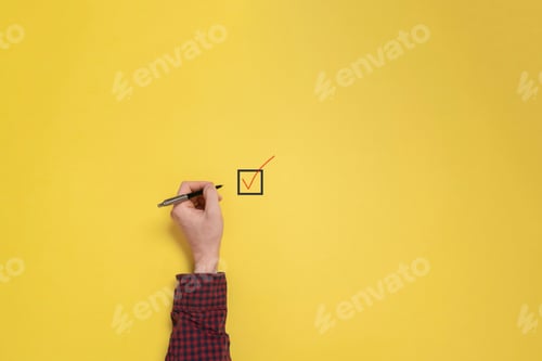 Preview: a businessman hand sign check mark box with a pen, view from above