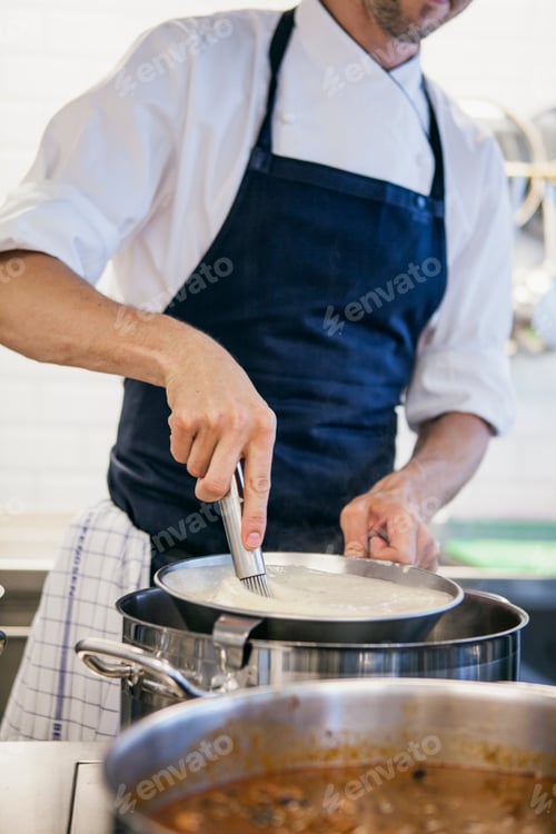 Preview: Chef whipping milk at restaurant kitchen