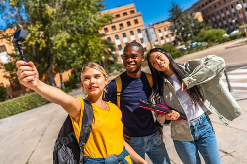 Preview: Multi-ethnic university students streaming online with small digital camera