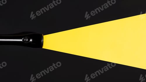 Preview: Flashlight shining on a dark background, flat lay. Light beam made of paper. Search concept, copy