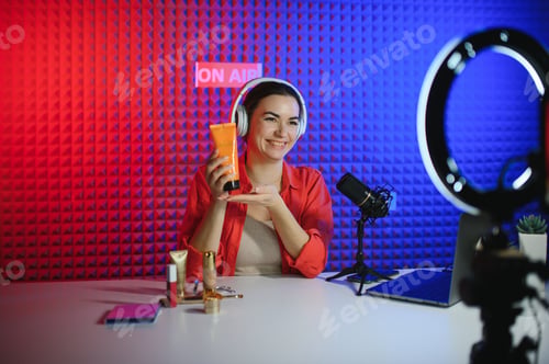 Preview: Young woman blogger recording video on camera