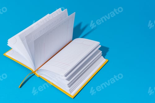 Preview: Opened Notebook On Blue Background With Copy Space