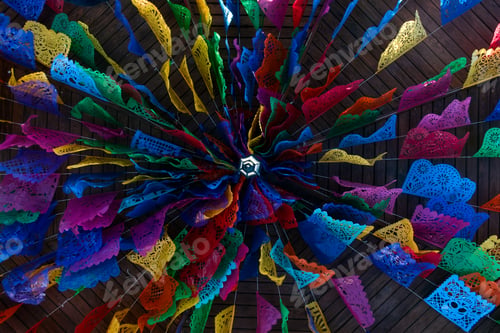 Preview: Day of the dead decorations with colorful papel picado on ceiling of Mexican house