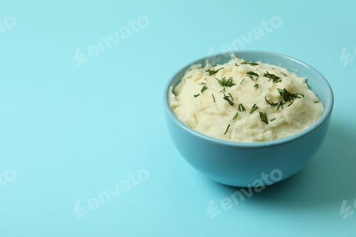 Preview: Plate of mashed potatoes on blue background