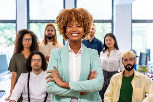 Preview: Proud african entrepreneur standing with arms crossed in a coworking