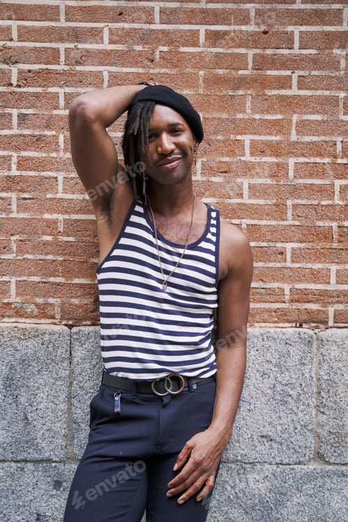 Preview: confident and city with an edgy black man outdoor in an urban town for fashion or street style.