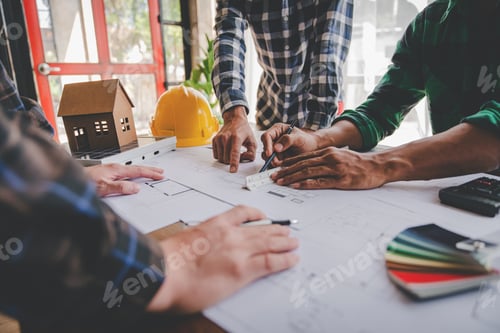 Preview: Engineers work as a team with blueprints for architectural plans. Engineer sketching construction pr