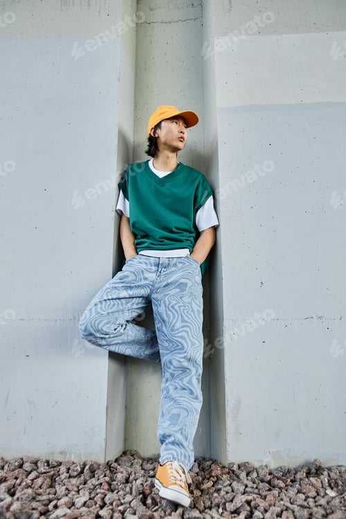 Preview: Asian man wearing colorful street style clothes in urban setting