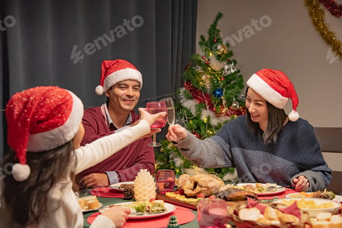 Preview: Family and daughter having dinner at Christmas celebration